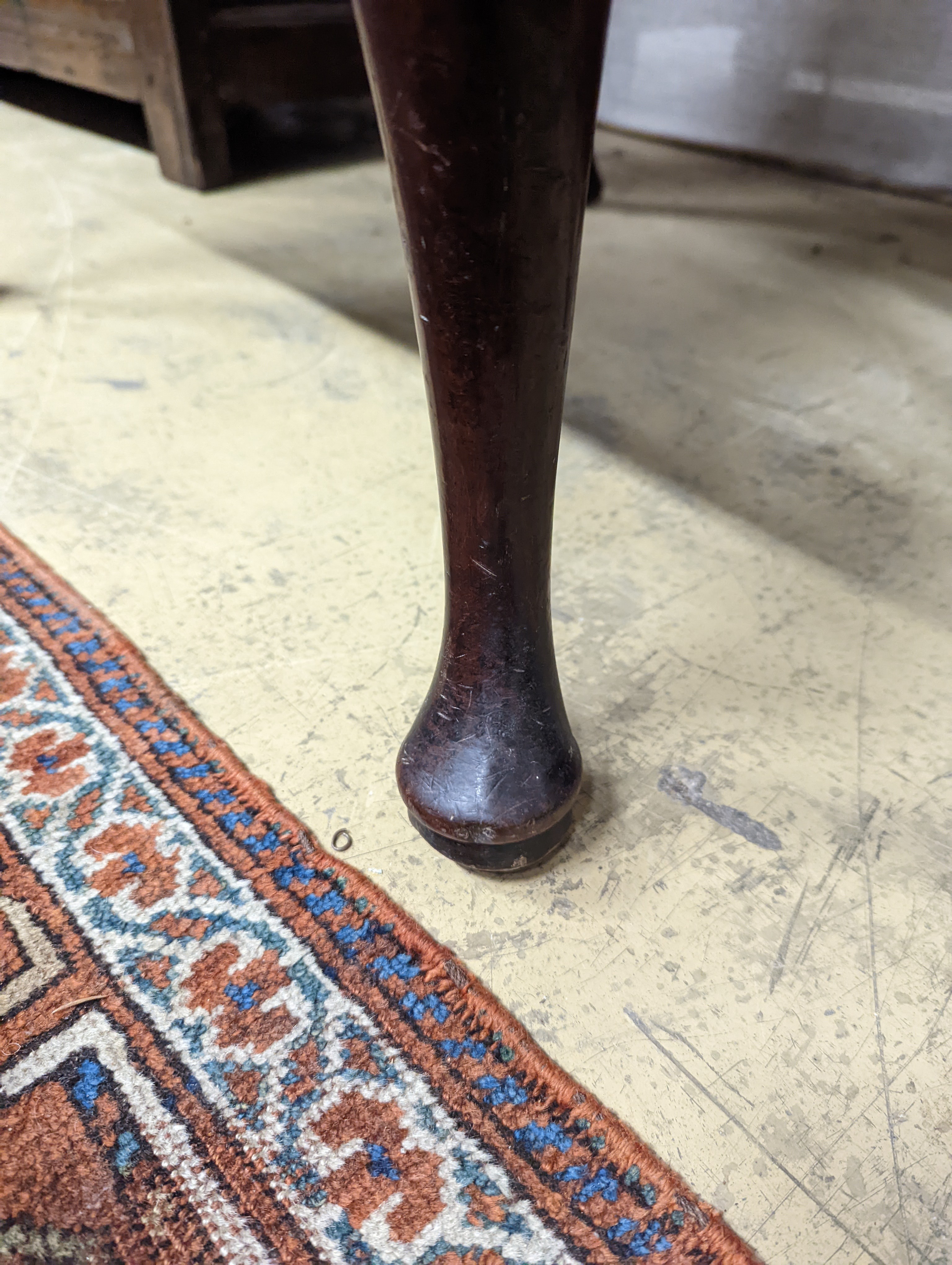 A George II mahogany wingback armchair, with slender cabriole legs and pad feet, width 80cm, depth 66cm, height 126cm